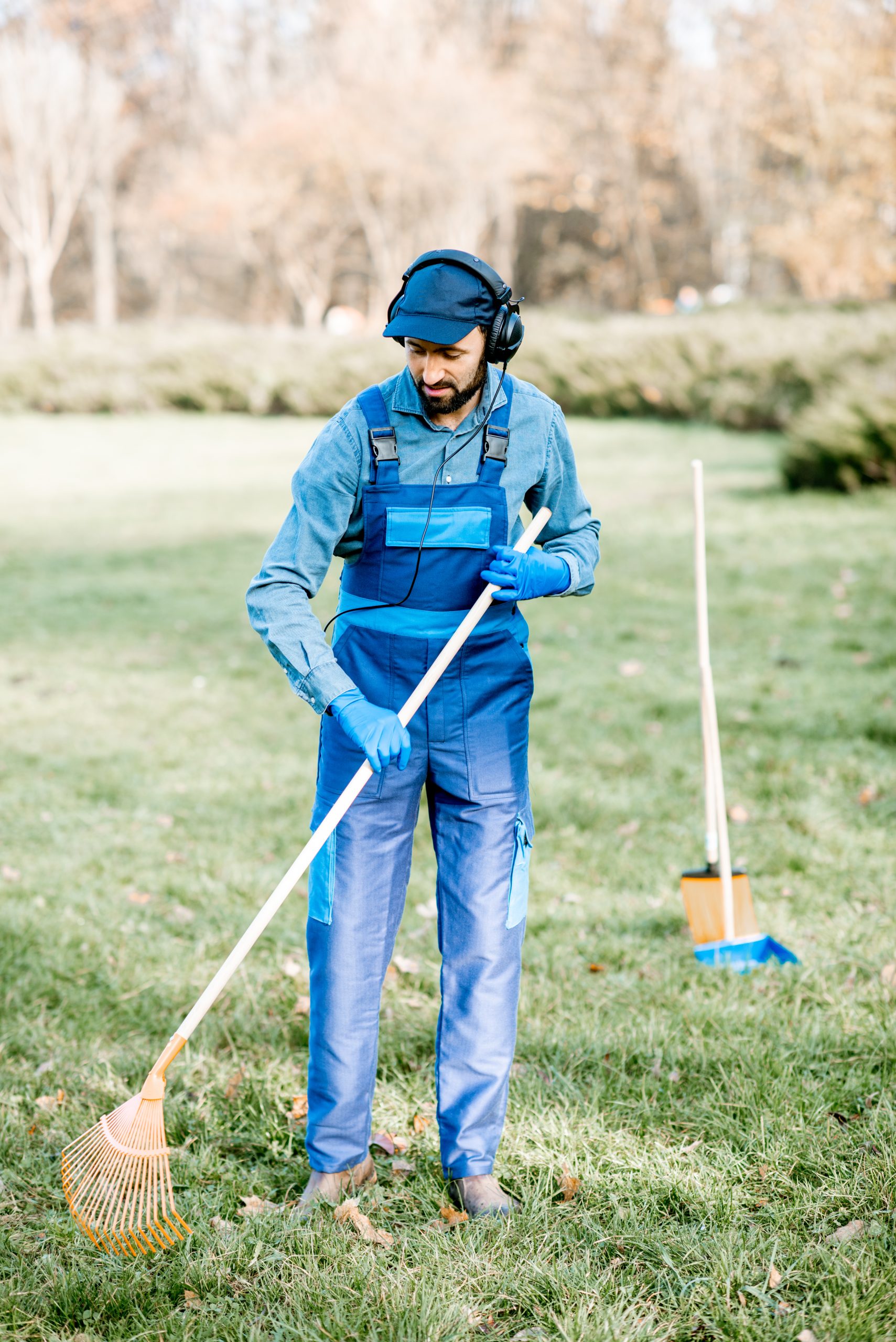Gardener with headphones during the work outdoors